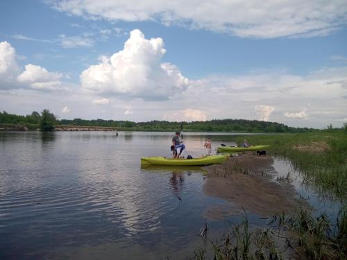 a group of people in boats on a lake at Chatka skrzatka in Kruki