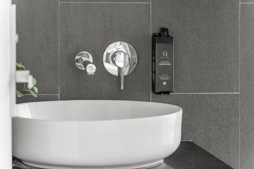 a bathroom with a sink and a tub at King Street Apartments by Urban Rest in Sydney