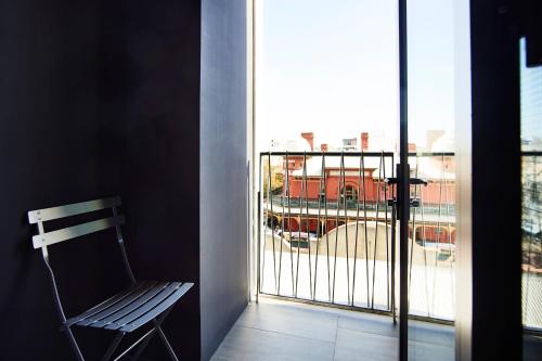 a balcony with a bench and a view of a building at Alex Hotel in Perth