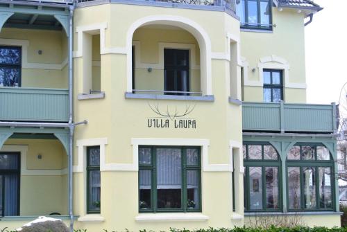 a yellow building with a sign that reads virtual tours at Villa Laura 12 in Kühlungsborn