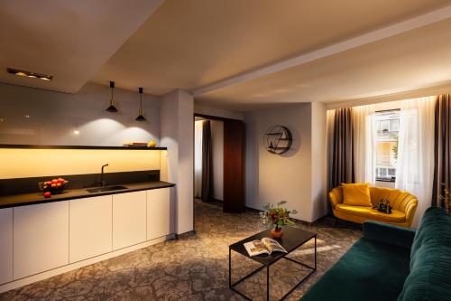 a living room with a couch and a table at Rosslyn Thracia Hotel Sofia in Sofia