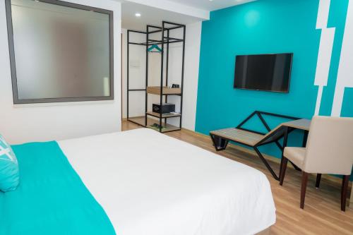 a bedroom with a bed and a desk and a tv at Khách Sạn X2 Vibe Việt Trì in Làng Tiên Cát