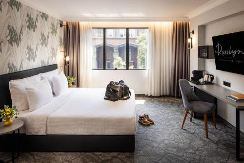 a hotel room with a bed and a desk at Rosslyn Thracia Hotel Sofia in Sofia