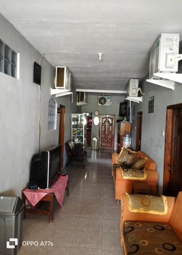a living room with couches and a flat screen tv at Pondok Family in Pangandaran