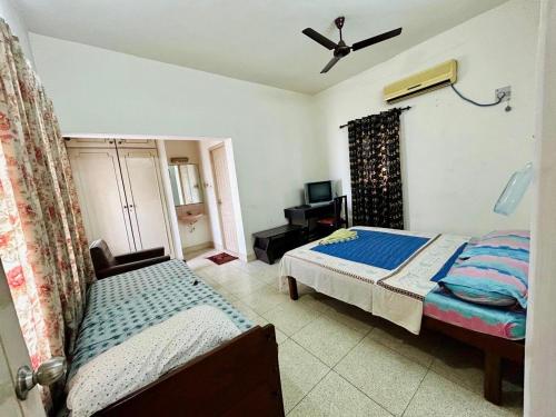 a bedroom with a bed and a tv in it at Deshadan Duplex homes in Trivandrum
