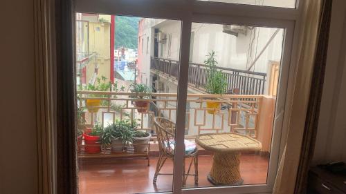a view of a balcony with a table and chairs at Rudram Hotel Yoga & Ayurveda Retreat in Rishīkesh