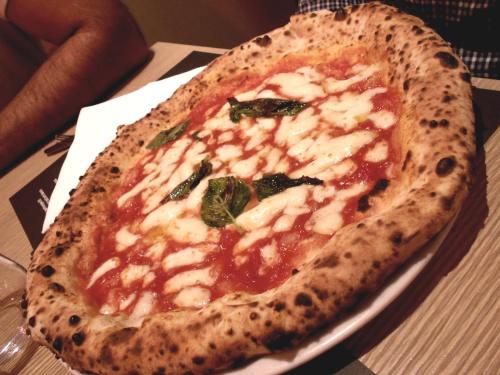 a pizza sitting on top of a plate on a table at Tenuta Montelaura in Forino