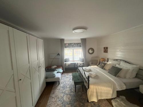 a bedroom with a bed and a couch at Apartmán Vidiek in Spišská Teplica