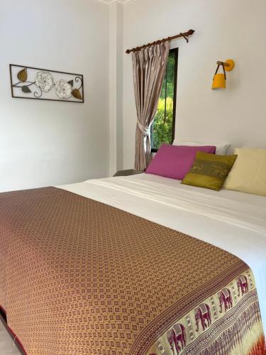 a large bed in a room with a window at Sawasdee Home Stay Resort & Pool in Khao Lak