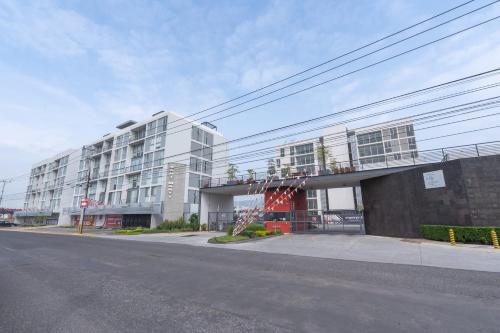 a building on the side of a street at Modern Apartment with Terrace and Pool Access in Guadalajara