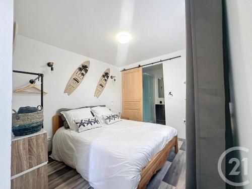 - une chambre avec un lit et des skis sur le mur dans l'établissement les petits chalets de kzo, à La Teste-de-Buch