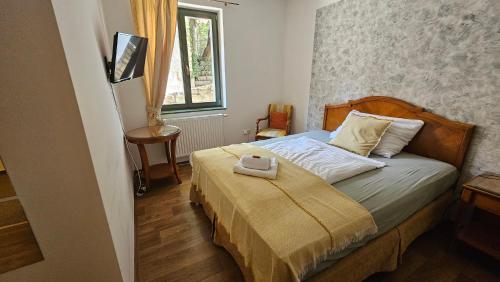 a bedroom with a bed with a tray on it at Hotel Opat in Kutná Hora