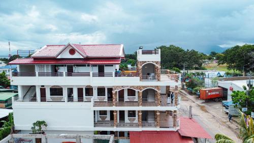 an overhead view of a white house with a red roof at Kaia Isabelle Inn in Puerto Princesa City