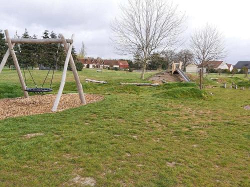 a playground with a swing set in a field at Cosy Billy - Appartement de charme in Billy
