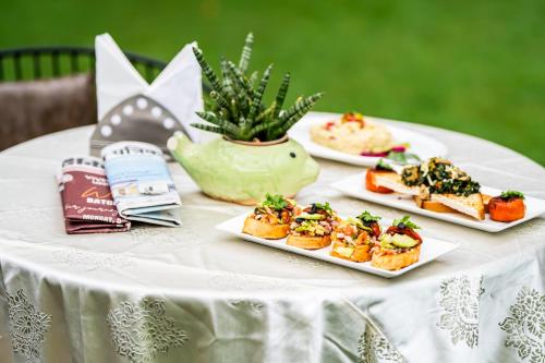 a table with three plates of food on it at The Marwar Hotel & Gardens in Jodhpur
