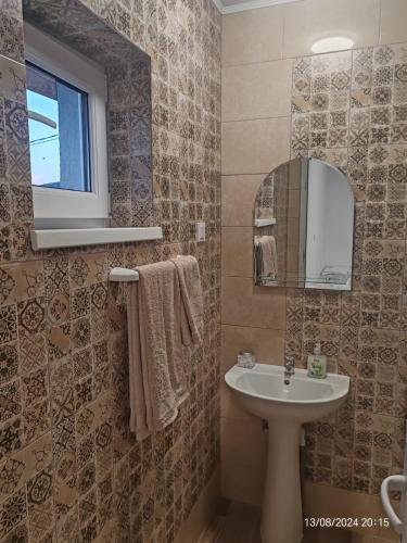 a bathroom with a sink and a mirror at Casa Gheorghe in Balabancea