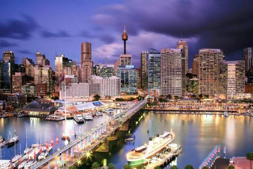 a city skyline with boats docked in a harbor at Rustic Queen Room - Conveniently Located - Shared Bathroom in Sydney