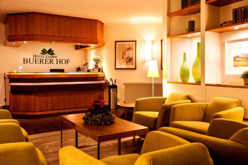 
a living room filled with furniture and a coffee table at Hotel Buerer Hof in Gelsenkirchen
