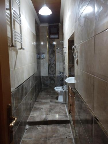 a bathroom with two sinks and a toilet in it at Asiye Hanım Konağı in Trabzon