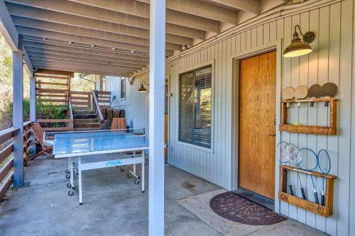 a ping pong table on the porch of a house at Stimboli Lodge- Sleeps 16 with tons of games and fun in Oakhurst