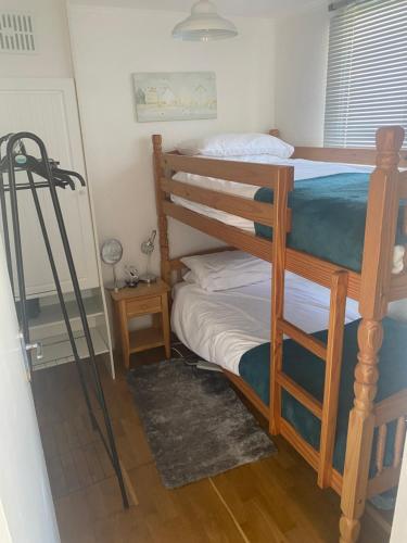 a bedroom with two bunk beds and a table at Kebbles retreat in Mablethorpe