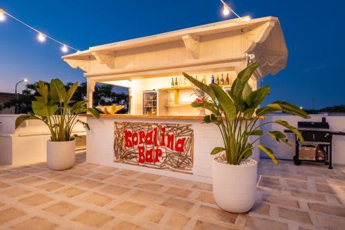 a restaurant with two potted plants in front of a building at Terrazza e Conchiglie in Torre Suda