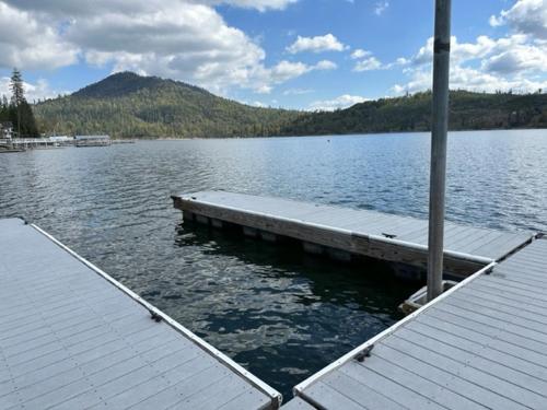 a dock in the middle of a large lake at Lakeview Lodge w/ Boat slip, hot tub, lake views in Bass Lake