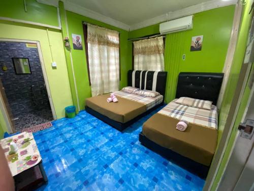 Ένα ή περισσότερα κρεβάτια σε δωμάτιο στο Perhentian Village Inn
