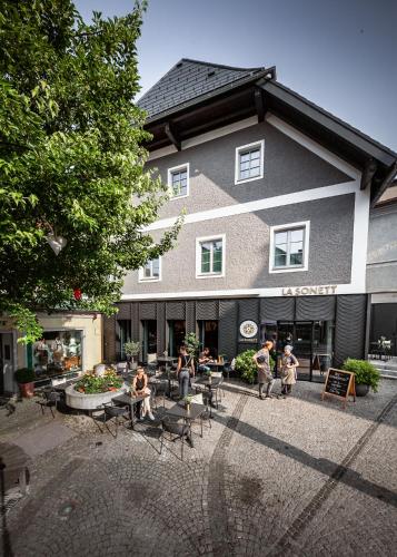 a group of people sitting outside of a building at La Sonett in Gmunden