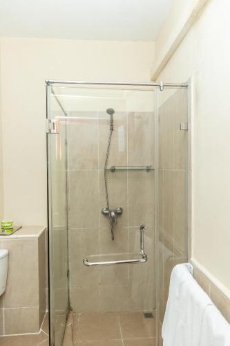 a shower with a glass door in a bathroom at Paradise Beach Club in Mirissa