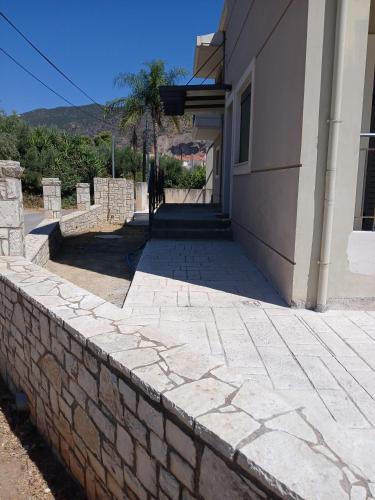 a stone retaining wall outside of a building at Simple, Calm and Luxurious in Kalamata