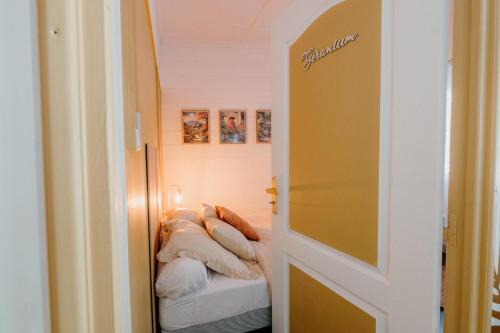a bedroom with a bed with pillows on it at La villa du jardin in Saint-Denis