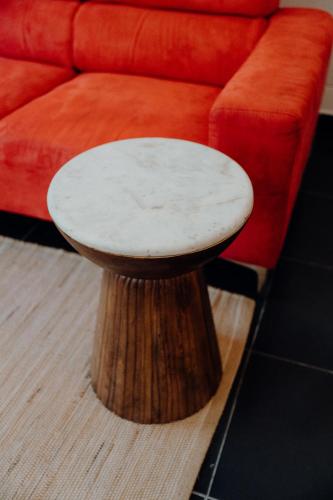 a wooden table sitting next to a red couch at La villa du jardin in Saint-Denis