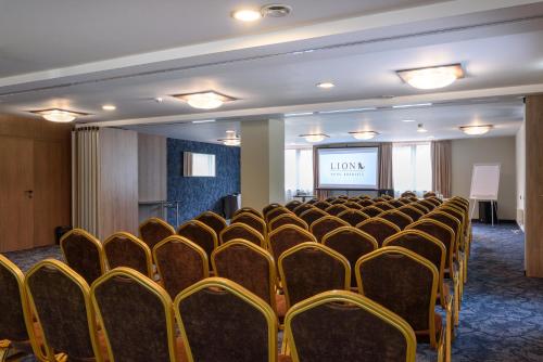 a row of chairs in a room with a screen at Lion Hotel Borovets in Borovets