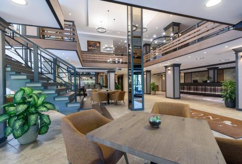 a lobby with a table and chairs and stairs at Lion Hotel Borovets in Borovets