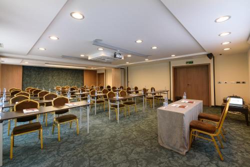 a conference room with tables and chairs in it at Lion Hotel Borovets in Borovets