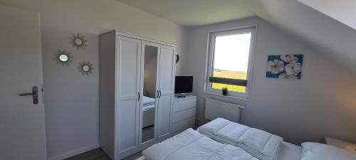 Katil atau katil-katil dalam bilik di Ferienhaus Watt`n Blick - nah an der Nordsee