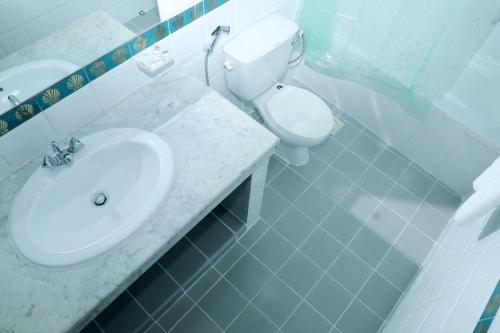 a white bathroom with a sink and a toilet at Blue Sky Way Hotel in Dubai