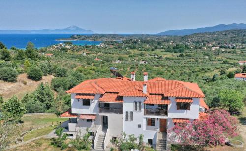 an image of a house with an orange roof at Paradiso Apartments New Luxury Flat in Ayios Nikolaos Sithonia
