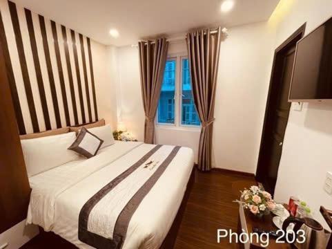 a bedroom with a large bed and a window at Villa Camellia in Da Lat