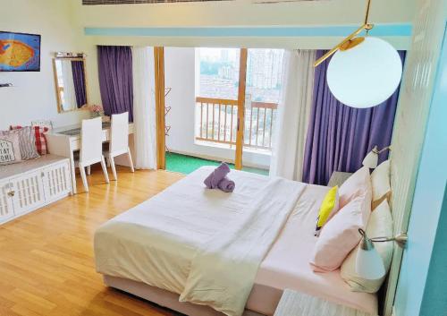 a bedroom with a large bed and a dining room at Exclusive Family Suites @ Sunway Pyramid Resort in Petaling Jaya
