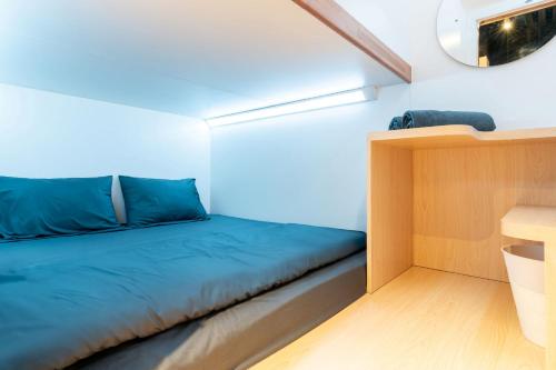 a small room with a bed and a desk at Bobopod Mega Mall, Bekasi in Pekayon Satu