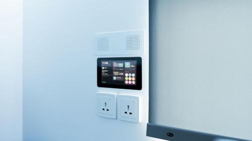 a room with an electronic device on the wall at Bobopod Mega Mall, Bekasi in Pekayon Satu