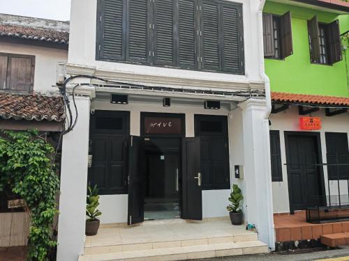 a building with black and white doors and windows at Cozy Home 3BR 8pax The Prive Malacca Jonker Street in Melaka