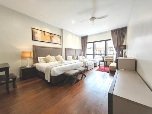 a large bedroom with a bed and a couch at Cozy Home 3BR 8pax The Prive Malacca Jonker Street in Melaka