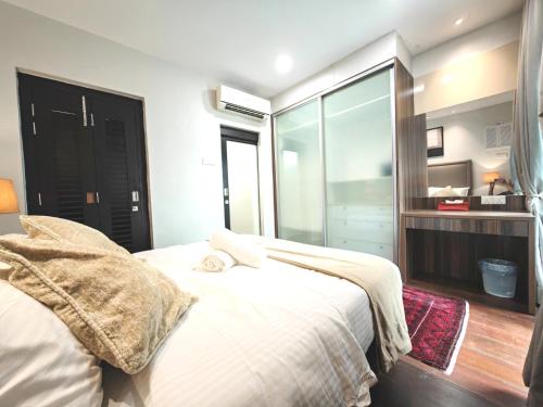 a bedroom with a white bed and a large window at Cozy Home 3BR 8pax The Prive Malacca Jonker Street in Melaka