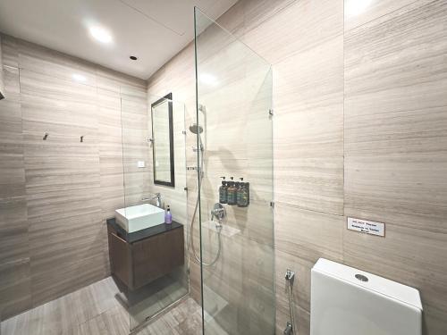 a bathroom with a shower with a sink and a toilet at Cozy Home 3BR 8pax The Prive Malacca Jonker Street in Melaka
