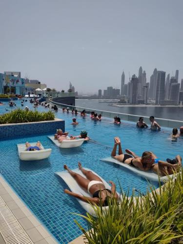 a group of people in boats in a swimming pool at 7 Palm Jumeirah in Dubai