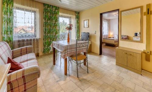 a living room with a table and a couch at Ferienhof Guglhupf in Sankt Oswald