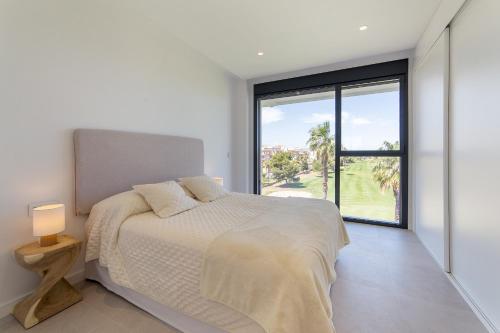 a bedroom with a bed and a large window at Oceans Oliva in Oliva